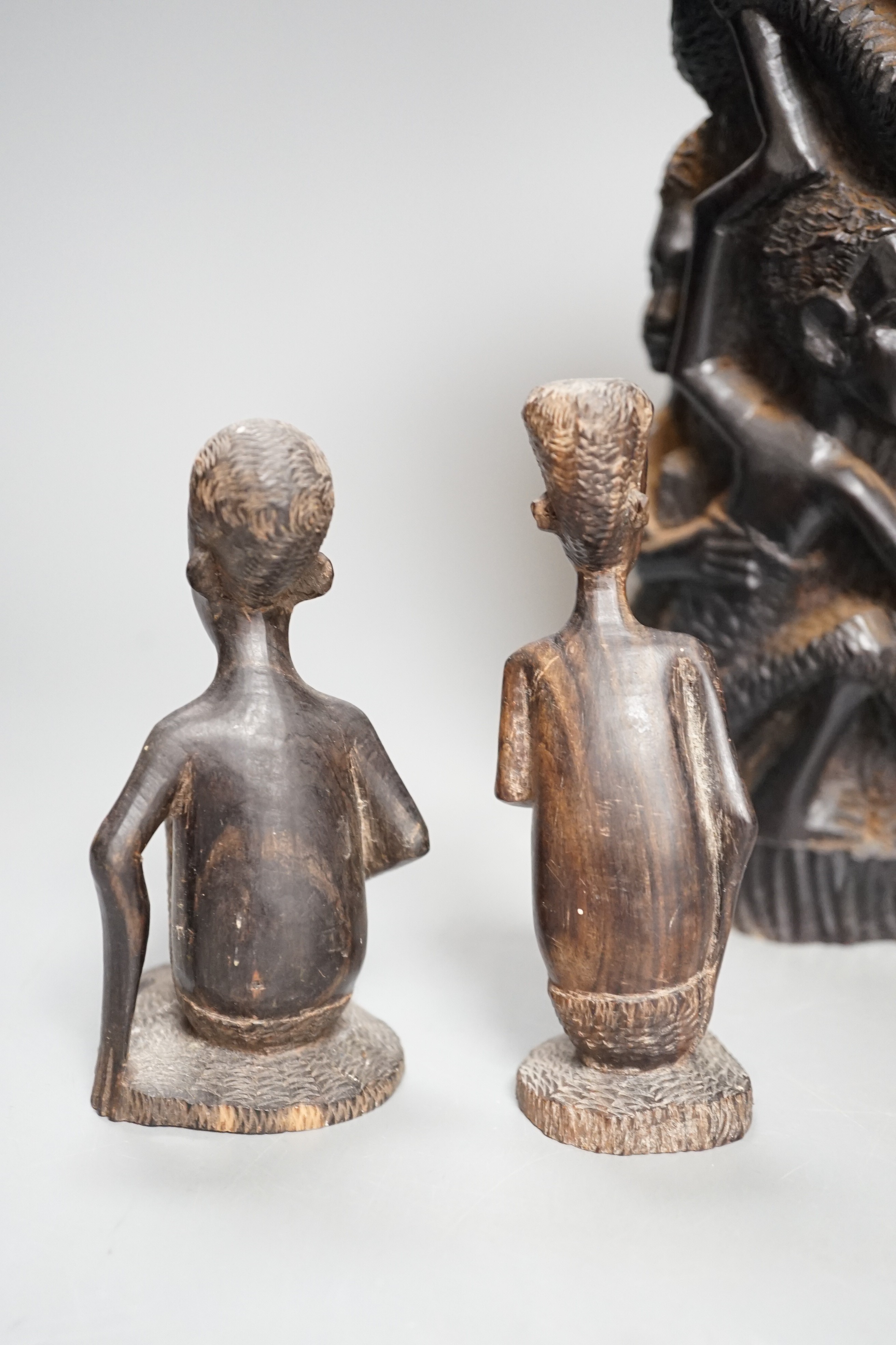 Four tribal hardwood carvings, two bows and two bronze spears longest 85cm